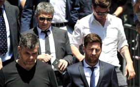 Lionel Messi (front right) and his father Jorge Horacio Messi (back left) leaving court.