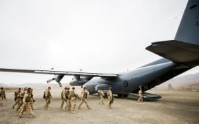 NZ Defence Force personnel boarding a Hercules plane.