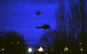 Helicopters fly over buildings in Dammartin-en-Goele, north-east of Paris, after the standoff between the two suspects and special forces.