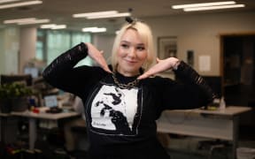 TAHI presenter/producer Evie Orpe proudly showing off her 'Sulfate' tee for NZ Music T-Shirt Day. The artwork featured on the shirt is by Peter Ruddell.