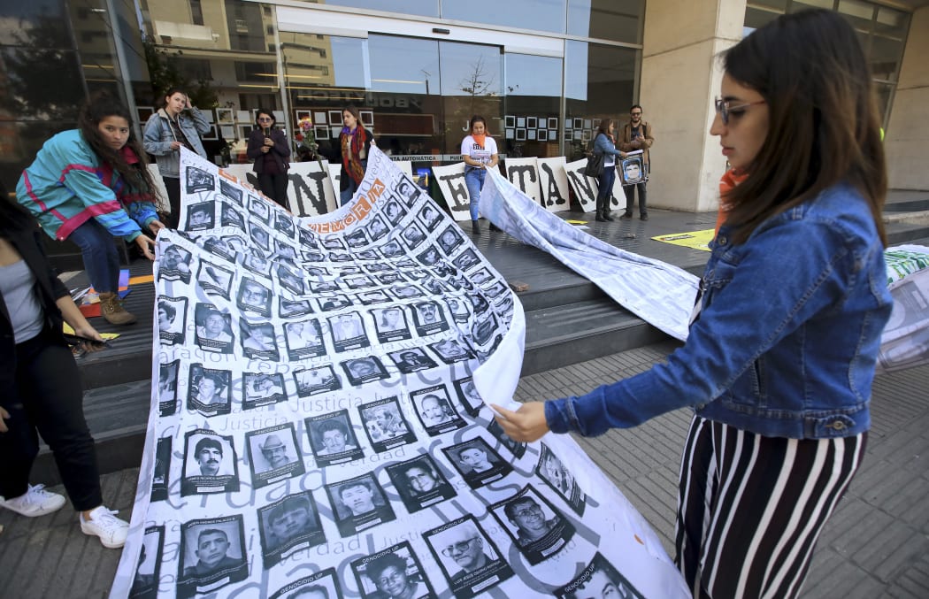 People demonstrate against the "false positives", executions of civilians at the hands of the military who presented them as combat casualties to swell results of the armed conflict.