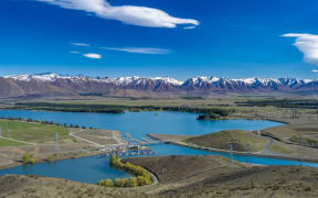 View of Lake Ruataniwha looking towards the Twizel township and Southern Alps.