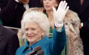 First lady Barbara Bush, waves to the crowd during George H W Bush's inauguration ceremony at the US Capitol on January 20, 1989.