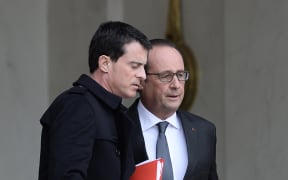 Prime Minister Manuel Valls (left) and President Francois Hollande leave a security meeting on Saturday.