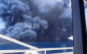 The eruption seen from the tourists' boat after they had left the island.