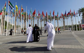 Delegates have their pictures taken at the venue of the COP28 United Nations climate summit in Dubai on November 30, 2023. The UN climate conference opens in Dubai on November 30 with nations under pressure to increase the urgency of action on global warming and wean off fossil fuels, amid intense scrutiny of oil-rich hosts UAE. (Photo by Giuseppe CACACE / AFP)