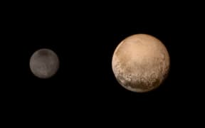 luto and Charon display striking color and brightness contrast in this composite image from July 11.