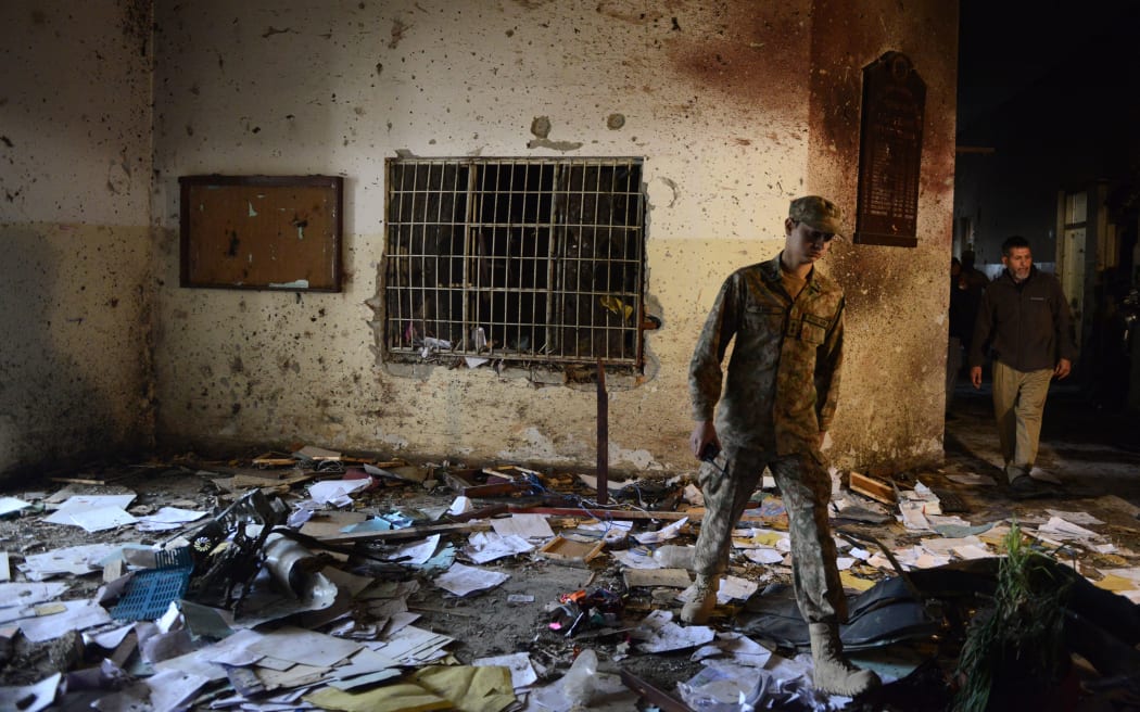 A Pakistani soldier in the army-run school in Peshawar where 141 people were killed by Taliban militants.