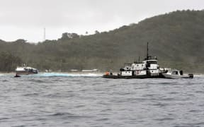Vessel remains stuck on American Samoa reef.