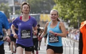 Melissa Moon, right, guiding blind runner Maria Williams in a half marathon in Wellington.
