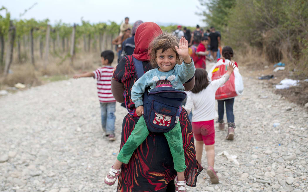 Refugees cross the border line between Greece and Macedonia near the town of Gevgelija.