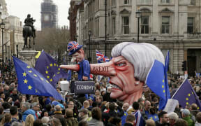 An effigy of British Prime Minister Theresa May is wheeled through Trafalgar Square during a Peoples Vote anti-Brexit march in London, Saturday, March 23, 2019.