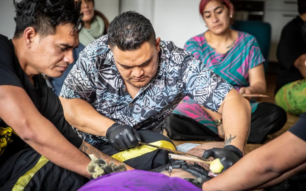 Tufuga ta tatau master tattooist, Li'aifaiva Imo Levi, is all concentration as he tattoos Deputy PM Carmel Sepuloni.