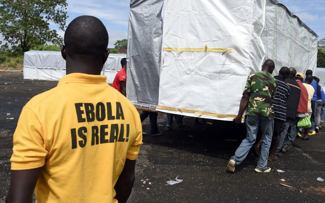 Workers setting up a new treatment center as part of the fight against Ebola in Liberia.