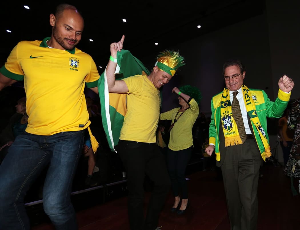 Brazil's ambassador to New Zealand, Eduardo Gradilone, dances with fans at half-time.