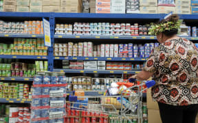A woman buying groceries in the Cook islands.