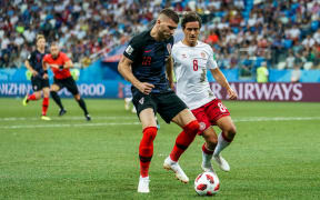 Ante Rebic of Croatia about to be challenged by Thomas Delaney of Denmark