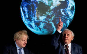 Britain's Prime Minister Boris Johnson (L) sits with British broadcaster and conservationist David Attenborough, during an event to launch the United Nations' Climate Change conference, COP26, in central London on February 4, 2020