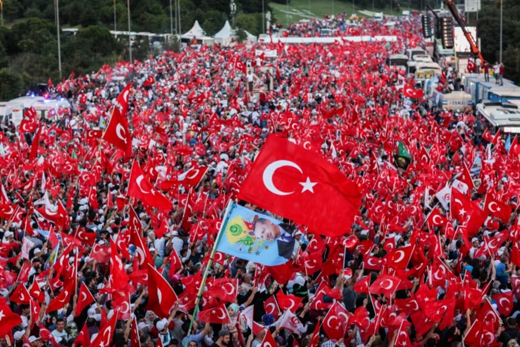 People wave Turkish national flags on July 15, 2017 during the first anniversary of failed coup in Istanbul.