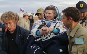 Expedition 44 crew member Gennady Padalka (centre) of Roscosmos is carried to the medical tent after landing in a remote area outside the town of Zhezkazgan in Kazakhstan on 12 September 2015.