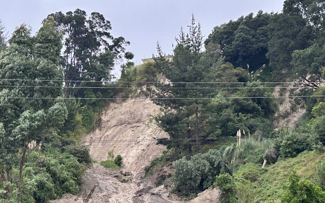 A house is seen perched at the edge of a large slip on Valley Road in Whakatāne following heavy rain on 3 May, 2023.