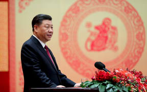 Chinese President Xi Jinping addresses a Chinese Lunar New Year reception at the Great Hall of the People in Beijing.