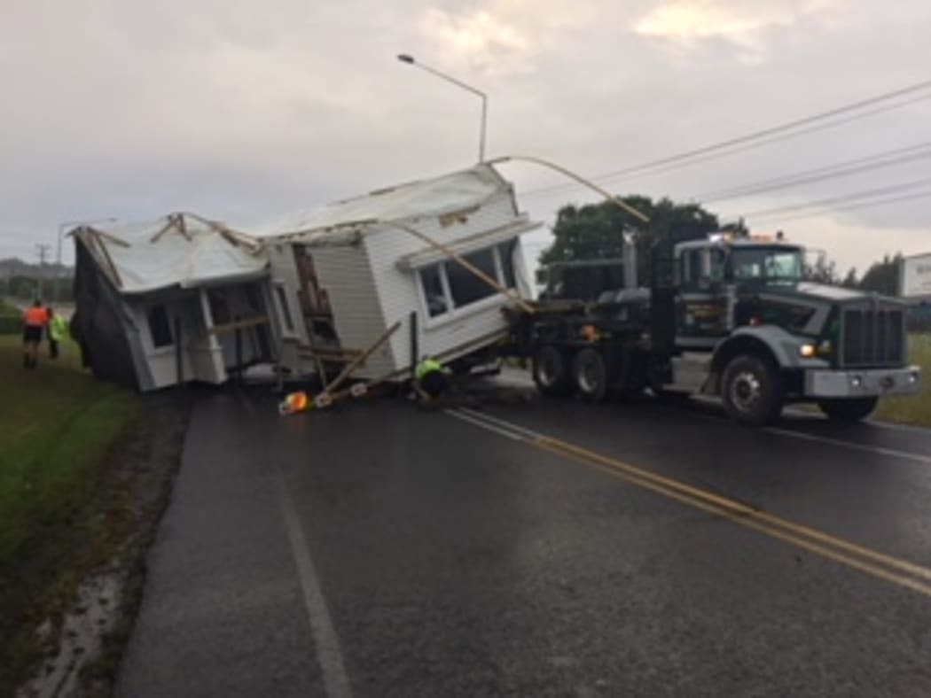 A house has fallen off a transporter on State Highway 16.