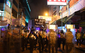 Policemen secure a street after dispersing pro-democracy protestors in the Sham Shui Po Area of Hong Kong.