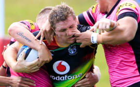 The Warriors' Ryan Hoffman is hooked in a tackle against the Penrith Panthers.