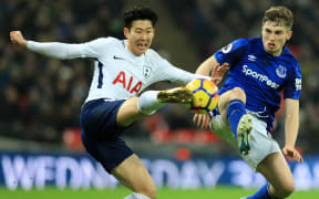 Spurs striker Son Heung-min and Michael Keane of Everton