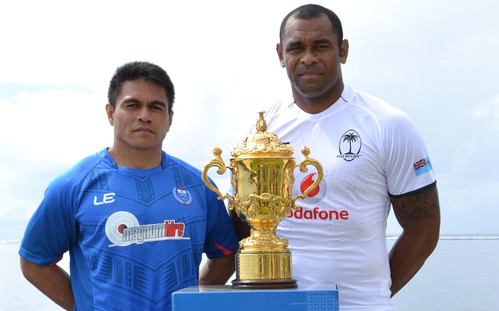 Samoa captain David Lemi and Fiji's Akapusi Qera pose with the Webb Ellis Cup ahead of Saturday's Pacific Nations Cup decider, which doubles as a World Cup qualifier.