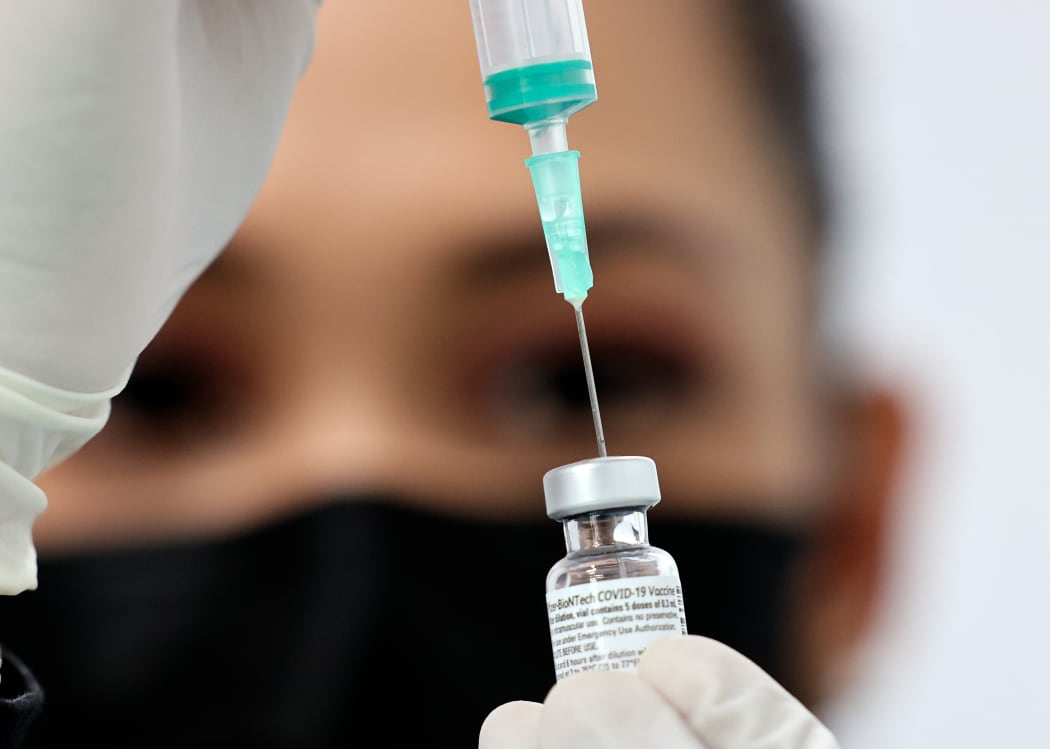 A health worker prepares an injection of the Pfizer-BioNTech vaccine against the coronavirus at a vaccination centre, set up at the Dubai International Financial Centre.