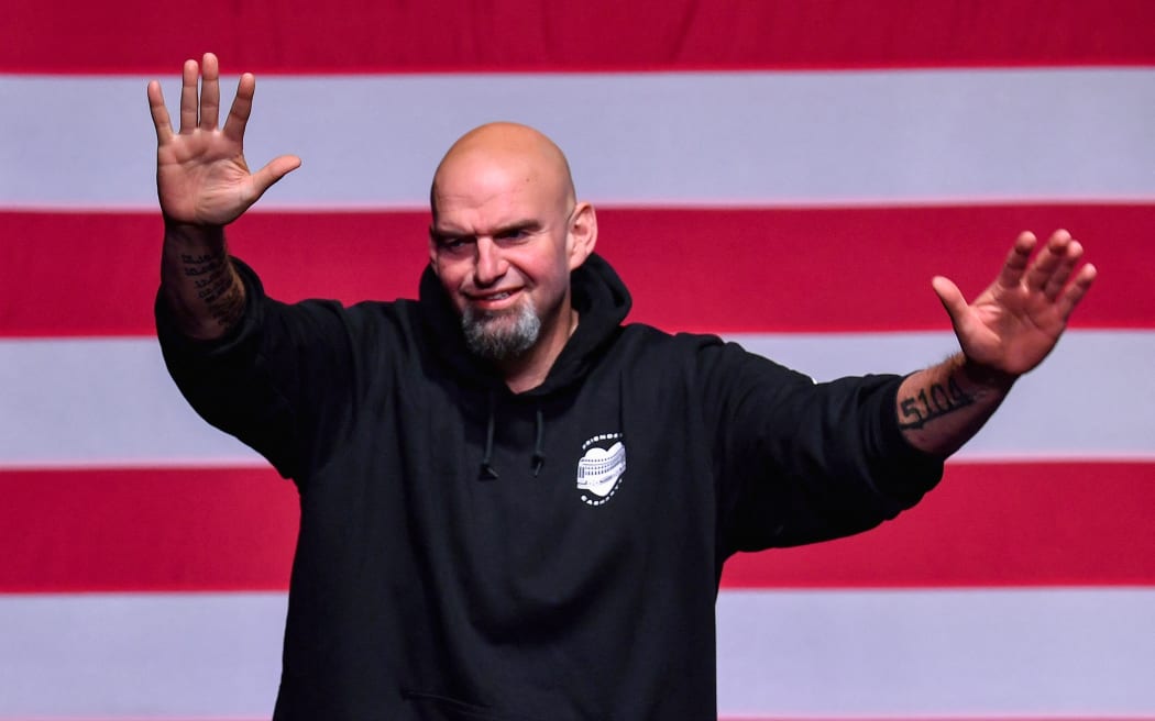 Pennsylvania Democratic Senatorial candidate John Fetterman waves onstage at a watch party during the midterm elections at Stage AE in Pittsburgh, Pennsylvania, 8 November 2022.