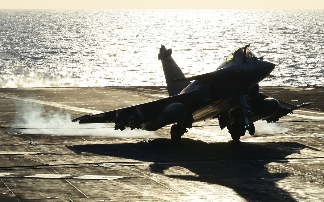 A warplane landing on French aircraft carrier Charles de Gaulle as part of an operation to strike Islamic State targets in Syria.