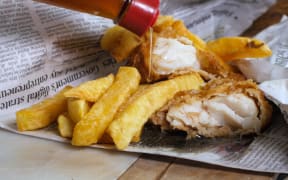 Fish and chips wrapped in newspaper.