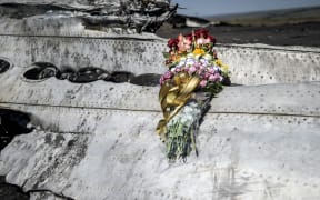 Flowers left by parents of an Australian victim of the crash, laid on a piece of the wreckage in eastern Ukraine