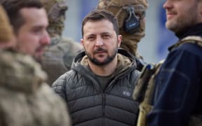 This handout photograph taken and released by Ukrainian Presidential press service on November 14, 2022, shows Ukrainian President Volodymyr Zelensky looking on during his visit to the newly liberated city of Kherson, following the retreat of Russian forces from the strategic hub.