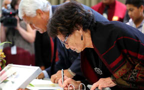 Ngati Hineuru kaumatua Te Reo Spooner signs the deed of settlement.