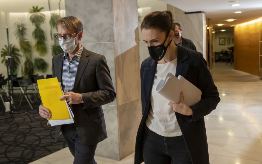 Prime Minister Jacinda Ardern and director general of health Dr Ashley Bloomfield leaving after the Covid-19 response and vaccine update at Parliament