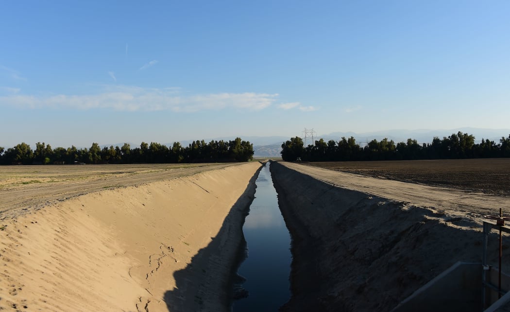An irrigation channel with a low water level near Bakersfield, California.