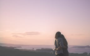 a couple hugging at sunset