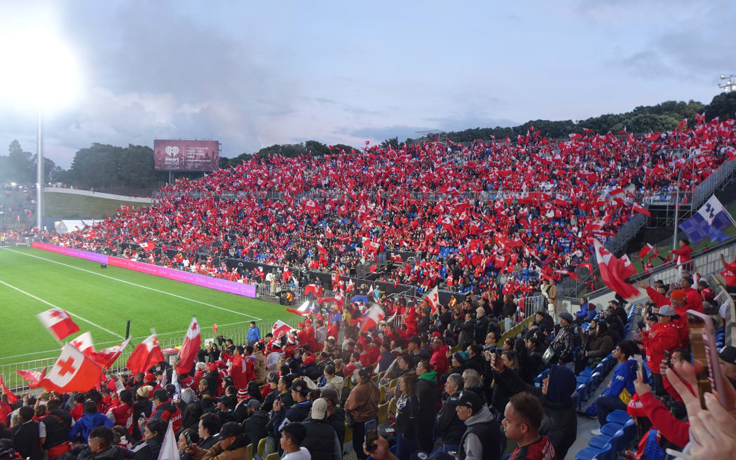 Fans wave the Tonga flag.