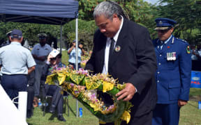 A family member lays a wreath at the RAMSI memorial