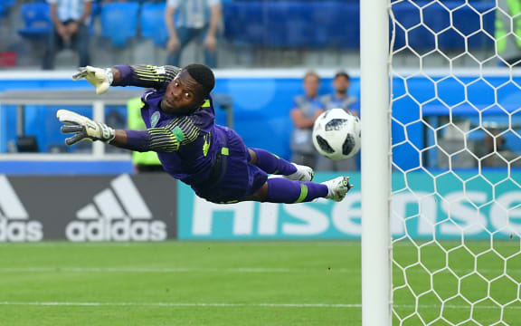 5560743 26.06.2018 Nigeria's goalkeeper Francis Uzoho jumps to make a save on a free kick by Argentina's Lionel Messi during the World Cup Group D soccer match between Nigeria and Argentina at the Saint Petersburg Stadium, in Saint Petersburg, Russia, June 26, 2018. Vladimir Pesnya / Sputnik