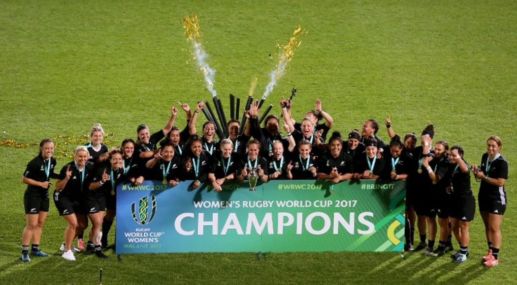 New Zealand's captain Fiao'o Faamausili holds the cup as players celebrate the fifth Black Ferns' world title.