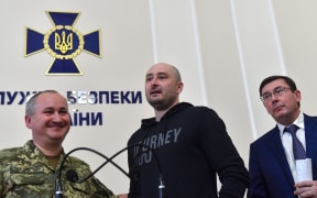 Russian journalist Arkady Babchenko, centre, with the head of Ukraine's security service Vasyl Grytsak, left, and prosecutor general Yuri Lutsenko.