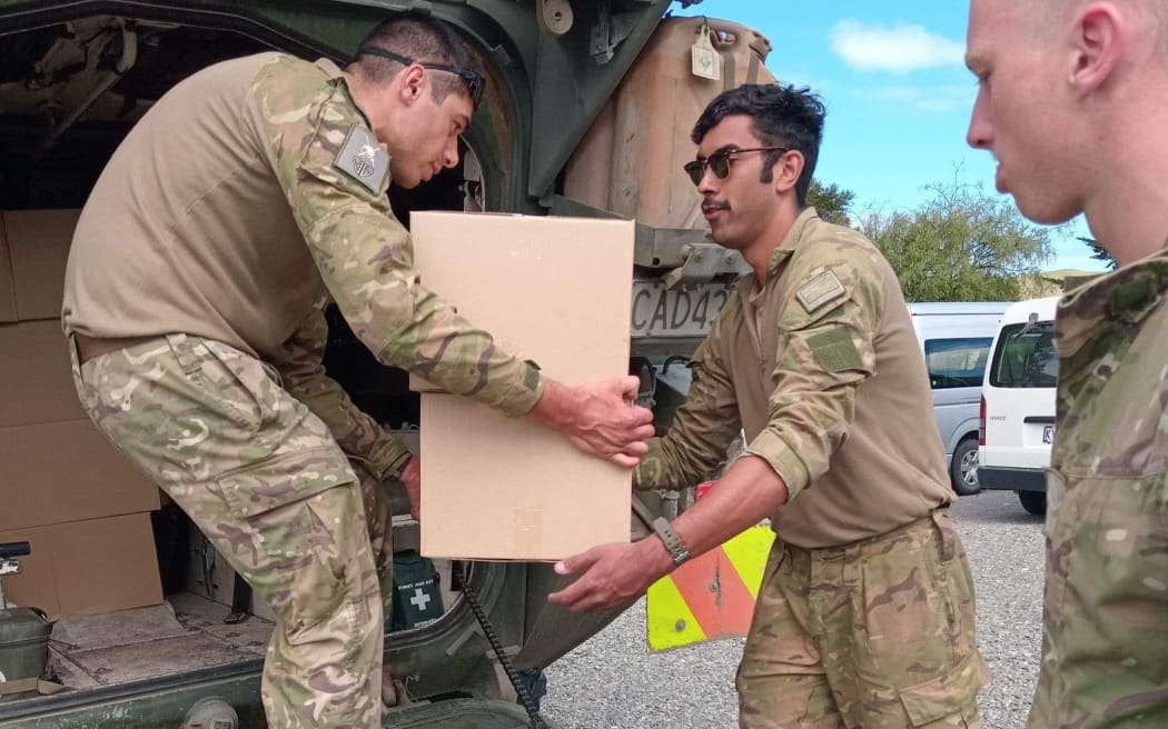 Army troops unloading supplies at Uawa, Tolaga Bay, after Cyclone Gabrielle