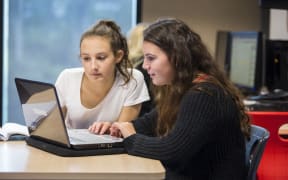 Stock photo of students using technology