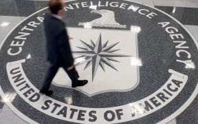 (File) A man crosses the Central Intelligence Agency (CIA) seal in the lobby of CIA Headquarters in Langley, Virginia, in 2018.