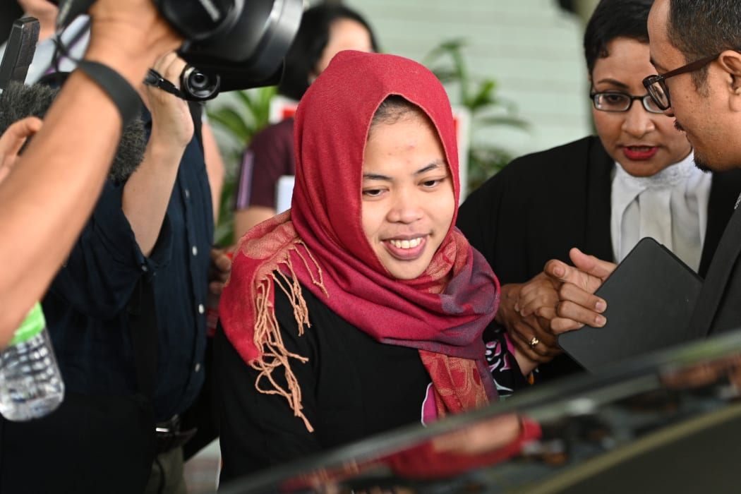 Indonesian national Siti Aisyah (C) smiles while leaving the Shah Alam High Court, outside Kuala Lumpur on March 11, 2019 after her trial for her alleged role in the assassination of Kim Jong-nam.